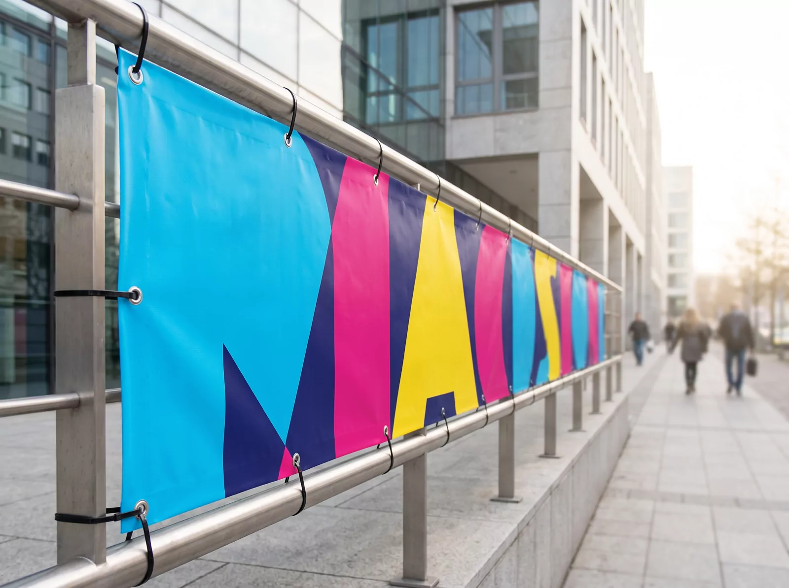 A printed banner fixed to railings on a city street