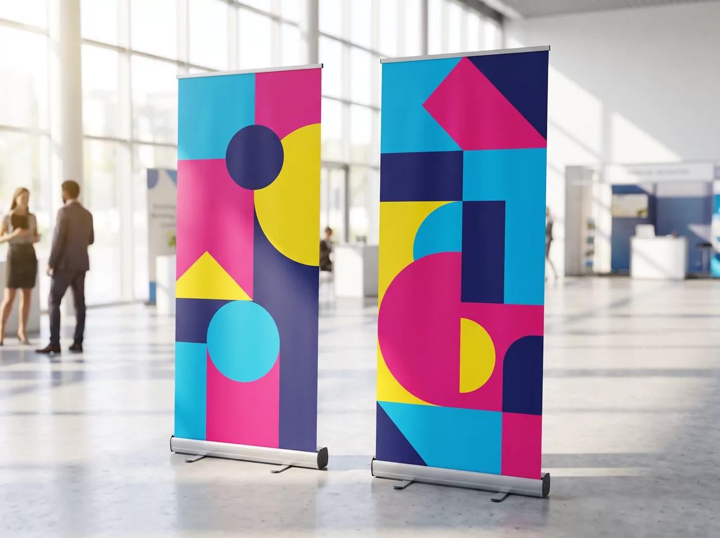 Two printed roller banners standing in an exhibition hall