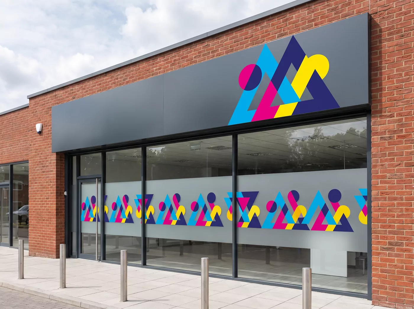 A shopfront with a printed fascia sign and window graphics