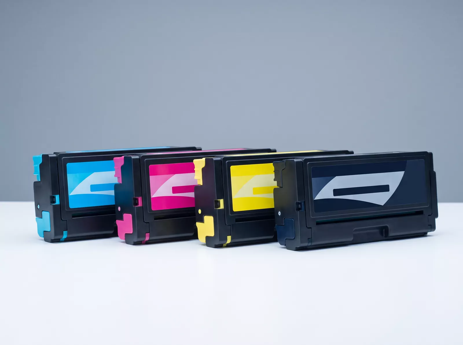 A row of toner cartridges in cyan, magenta, yellow and black